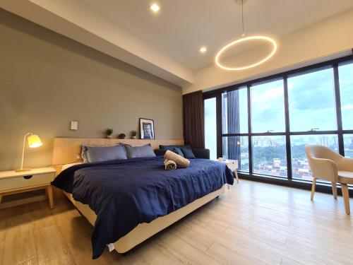 a bedroom with a large bed and a large window at M city service suite KLCC in Kuala Lumpur