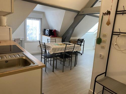 a kitchen and dining room with a table and chairs at Gites Plein Ciel in Rethel