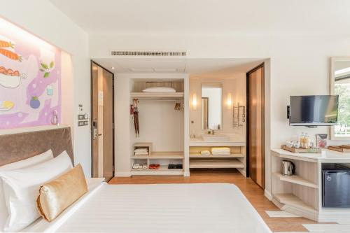 a hotel room with a bed and a bathroom at Sand Dunes Chaolao Beach Resort in Chao Lao Beach