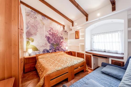a bedroom with a bed and a window at Agriturismo Le Mimose in Imperia