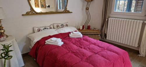 a bedroom with a pink bed with towels on it at Bologna Minimal Chic House Relax Parking Nature Near Center in Bologna