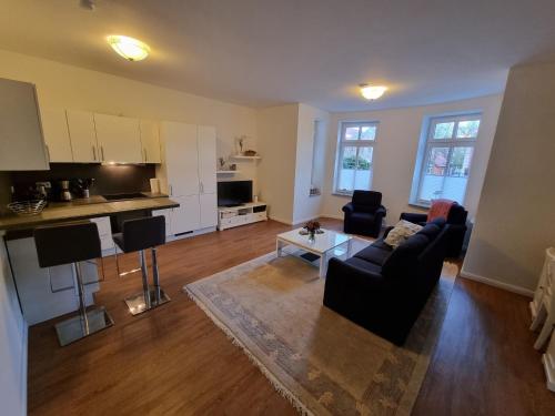 a living room with a couch and a table at Villa Schönfeld Wohnung 1 in Papenburg