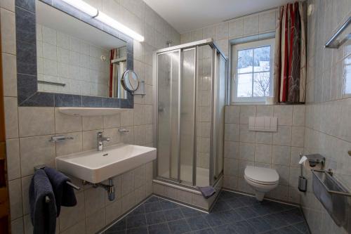 a bathroom with a sink and a shower and a toilet at Gidis Hof in Ischgl