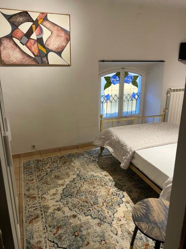 a bedroom with a bed and a window and a rug at Mood-Garibaldi 26 in Pavia