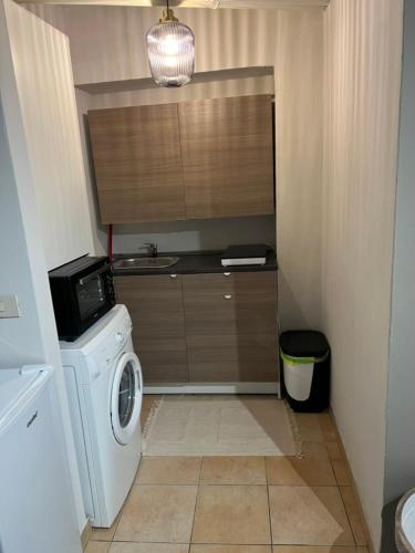 a laundry room with a washing machine and a sink at Mood-Garibaldi 26 in Pavia