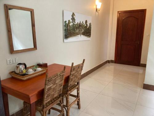 a dining room with a wooden table and chairs at Lily Pad Boutique Hotel in Siem Reap