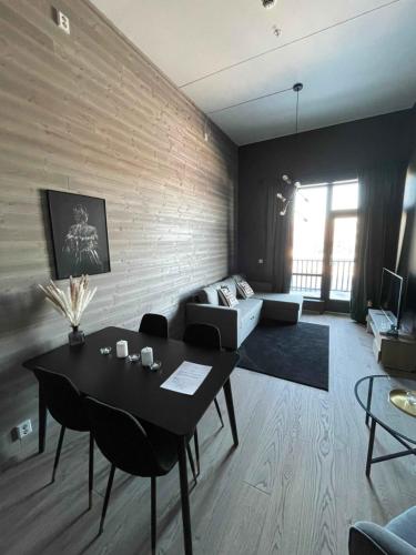 a living room with a table and a couch at Trysil Alpine Lodge in Trysil