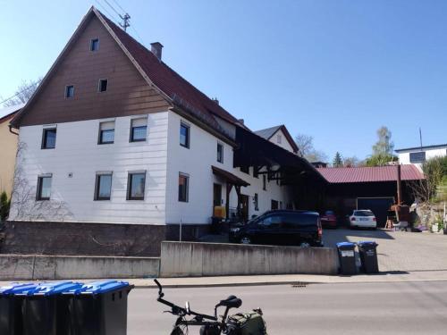 a bike parked in front of a white building at Monteurzimmer Ringingen in Erbach