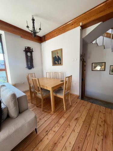 a dining room with a wooden table and chairs at Willa Art Deco in Ustroń