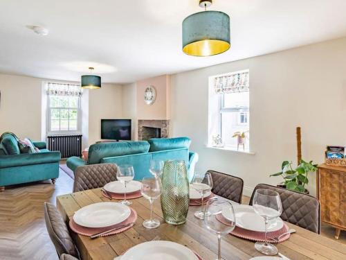 a dining room with a table with wine glasses at Northdene - 5 star Lake District Cottage in Cockermouth