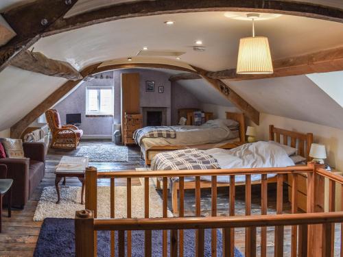 a bedroom with two beds in a attic at Wards Court 2 - Uk41275 in Frampton on Severn
