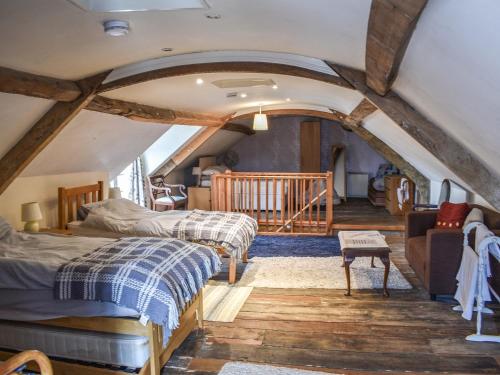 two beds in a room with an attic at Wards Court 2 - Uk41275 in Frampton on Severn