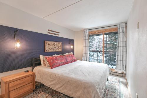 a bedroom with a large bed and a window at Trails End Condo in Breckenridge