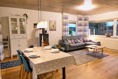 a living room with a table and a couch at Apfelhaus beim Hennesee in Meschede