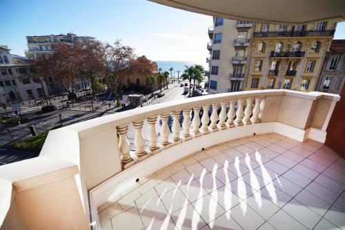a balcony with a white railing and a street at Domes Seaside Résidence Piscine, Free Parking, Airport Tramway in Nice