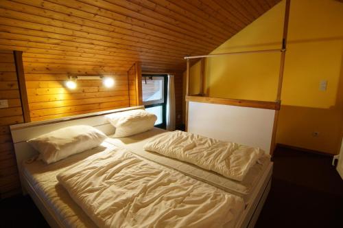 a bedroom with a bed with two pillows at Terrassenpark Apartments (low budget) in Sasbachwalden