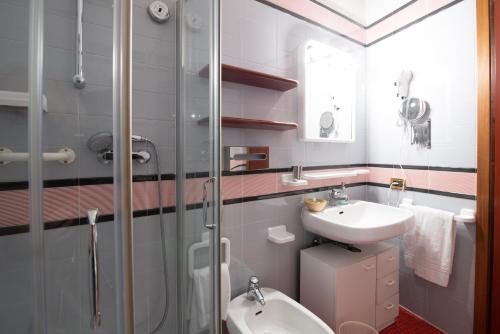 a bathroom with a toilet and a sink and a shower at Residence La Fenice in Padova