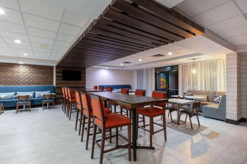 a dining room with a long table and chairs at Wingate by Wyndham - DFW North in Irving