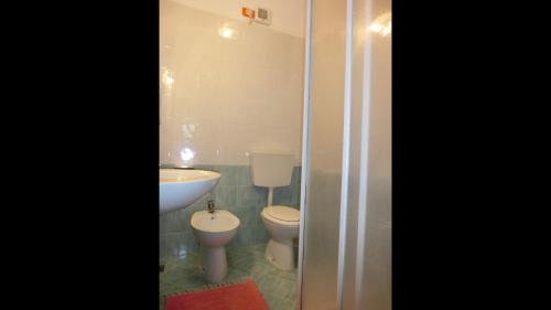 a bathroom with two toilets and a sink at Nice flat with terrace in a great spot - Beahost in Bibione
