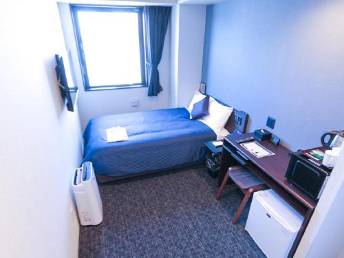 東京的住宿－HOTEL LiVEMAX Akasaka，配有一张床、一张书桌和一扇窗户的酒店客房