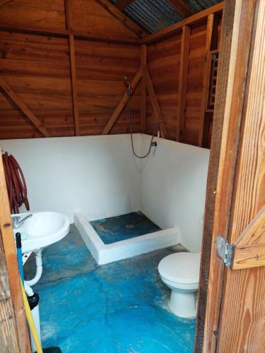 a bathroom with a toilet and a sink at Cabana Playa Cambiaso in San Felipe de Puerto Plata