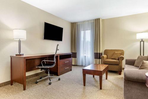 a hotel room with a desk and a chair at Comfort Inn & Suites Clemson - University Area in Clemson