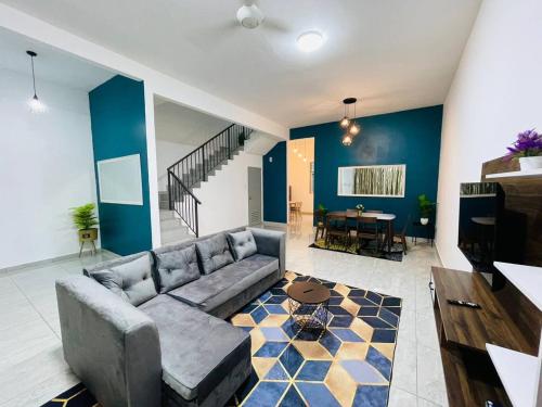 a living room with a couch and a table at D’MARCO HOMESTAY in Kulai