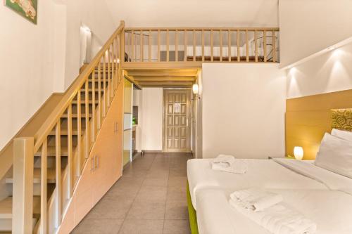 a bedroom with a bed and a staircase at Kalogria in Stoupa