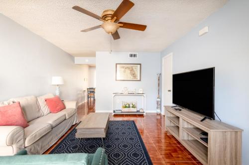 a living room with a couch and a flat screen tv at Amazing 2 Bedroom Townhouse near beach in Indialantic