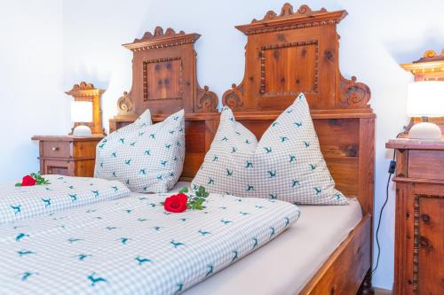 a bedroom with two beds with blue and white pillows at Ferienhaus Mittersill am Biohof Widholz in Mittersill