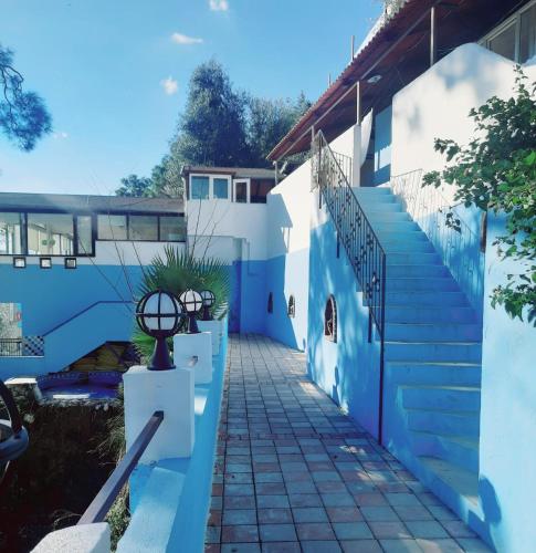 a blue and white building with a stairway at Belle Vue Ölüdeniz in Fethiye