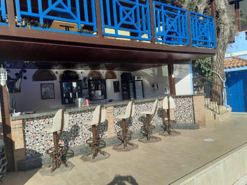 a row of bar stools in front of a building at Belle Vue Ölüdeniz in Fethiye