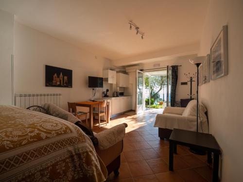 a bedroom with a bed and a living room at Tra Gli Ulivi in Pietra Ligure