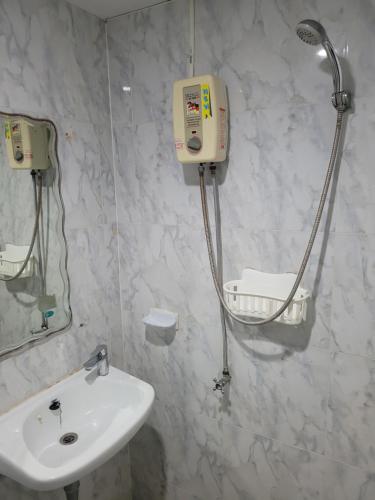 a bathroom with a sink and a shower at 2 Vikings Guesthouse in Karon Beach