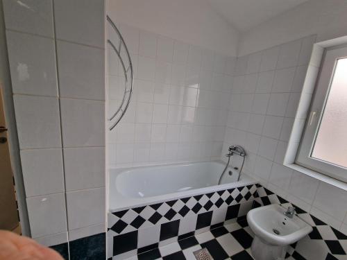 a bathroom with a bath tub and a toilet at Apartmani Carla in Medulin