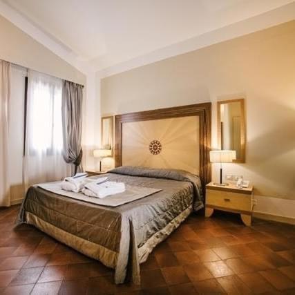 a bedroom with a bed with two towels on it at Villa dei Tigli 920 Liberty Resort in Rodigo