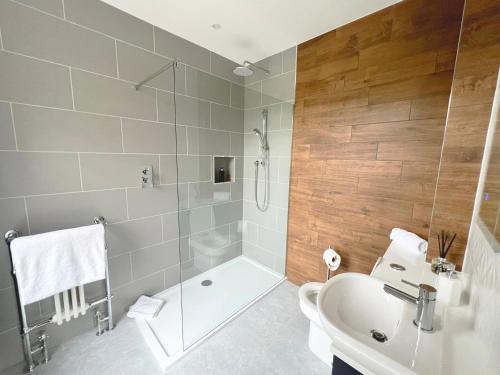 a bathroom with a shower and a toilet and a sink at West Hendford House - Apt 1 in Yeovil