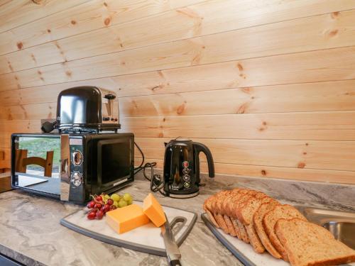 a counter top with bread and cheese and a toaster at Cherry in Ulverston