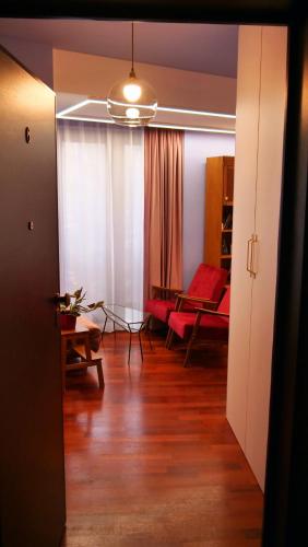 a living room with a red couch and a table at Downtown Italian Studio in Bucharest