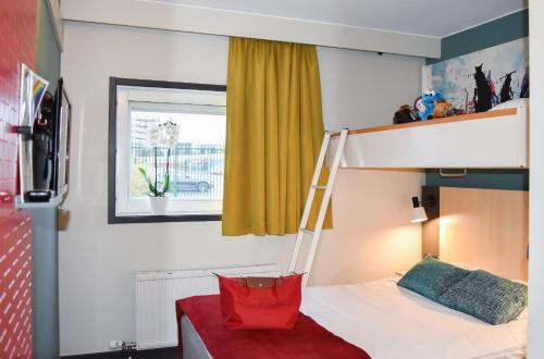 a bedroom with a bunk bed with a red bag on it at Good Morning Mölndal in Mölndal