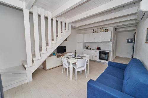 uma sala de estar com um sofá azul e uma mesa em Affittimoderni Isola Rossa Borgo - IRGI11 em Isola Rossa