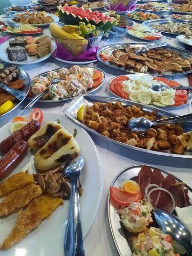 a table full of different types of food on plates at Motel HEKO in Bugojno