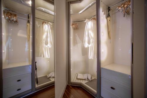 a walk in closet with two mirrors and dresses at VISTA Lago di Como in Como