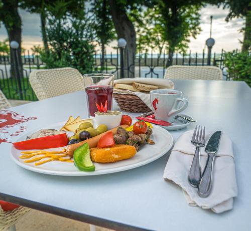 a plate of food sitting on a table with a drink at Mera Brise in Mangalia