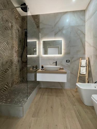 a bathroom with a sink and a shower at Suite Élite in Catania