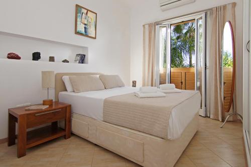 1 dormitorio con cama, mesa y ventana en Villa Polina, en Ayia Napa