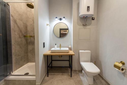a bathroom with a sink and a toilet and a shower at Idea Design Apart-Hotel Prorizna in Kyiv