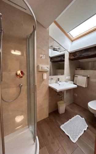 a bathroom with a shower and a sink at Roter Adler in Caldaro