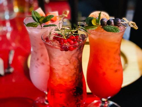 three cocktails sitting on top of a table at Pensjonat Orlik Mountain Resort&SPA in Bukowina Tatrzańska