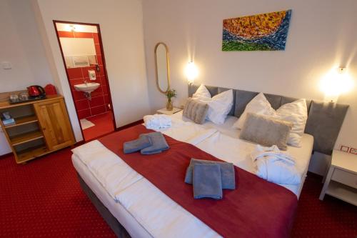 a bedroom with a large bed with towels on it at Wellness & Restaurant U Fandy in Lhotka